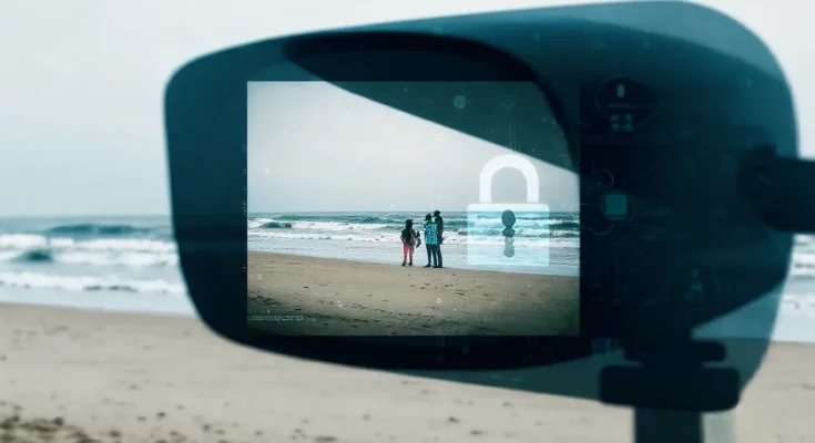 AI surveillance risks represented by a vacation photo at a beach, featuring waves and sand with a digital overlay of data points and privacy concern symbols, illustrating how AI can analyze personal images to track individuals.